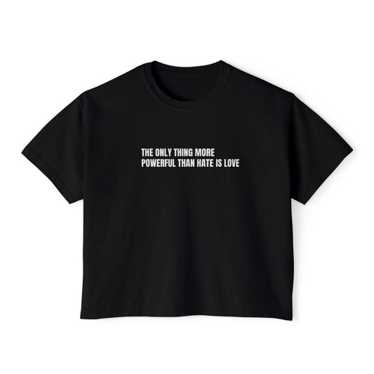 Black t-shirt with text design "THE ONLY THING MORE POWERFUL THAN HATE IS LOVE" on a white background