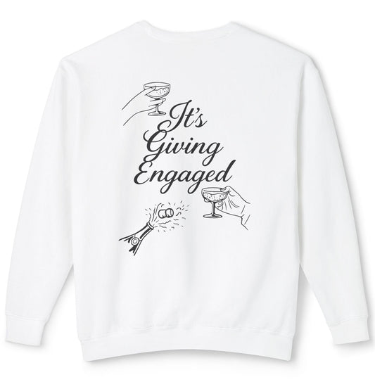 White sweatshirt with 'It's Giving Engaged' text and champagne glass illustrations on a white background