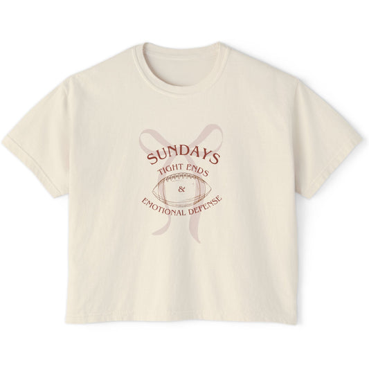 Beige t-shirt with graphic design and text on a white background