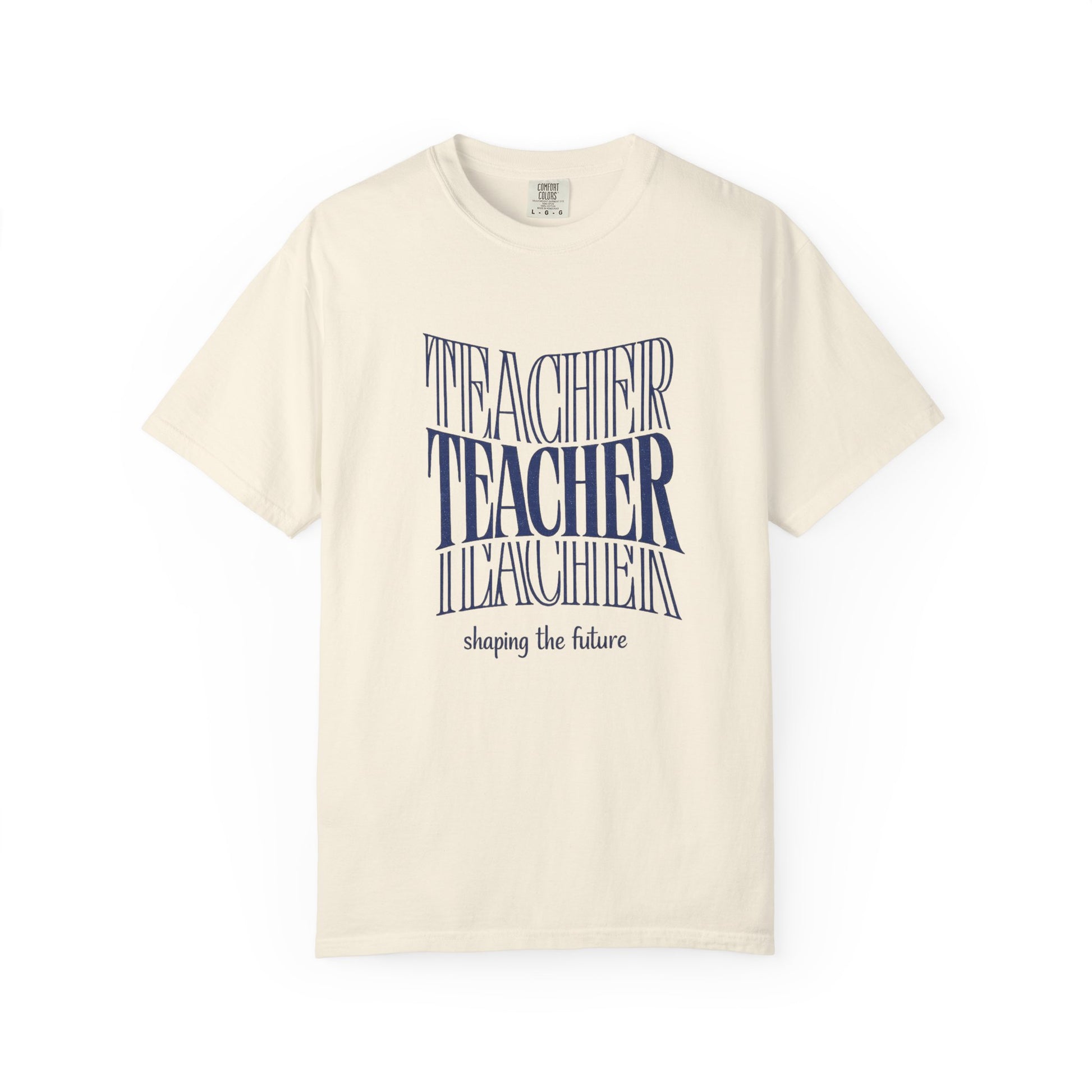 Beige t-shirt with blue text "Teacher shaping the future" on a white background