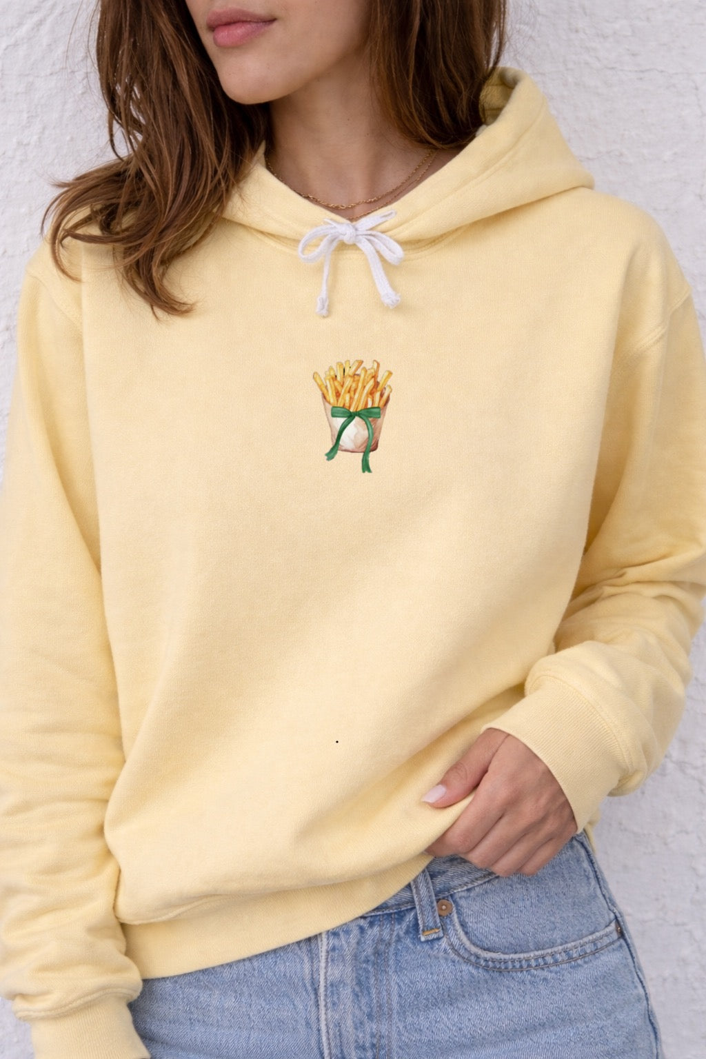 Yellow hoodie with a French fry design on a white background
