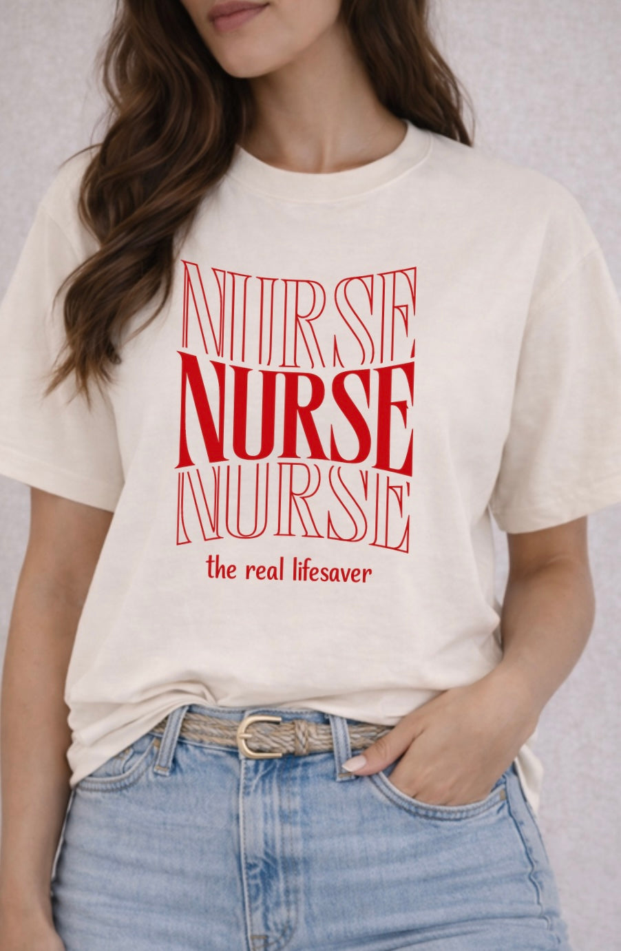 Person wearing a white t-shirt with 'NURSE the real lifesaver' text in red.
